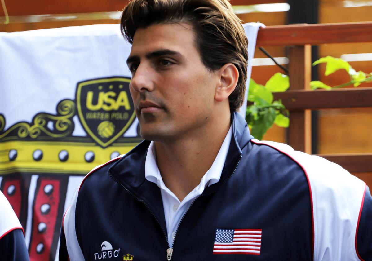 Newport Harbor High graduate Luca Cupido stands after being named to the U.S. 2024 Olympic men's water polo team