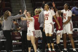 Southern California coach Lindsay Gottlieb, left, and players celebrate as they defeat Arizona.