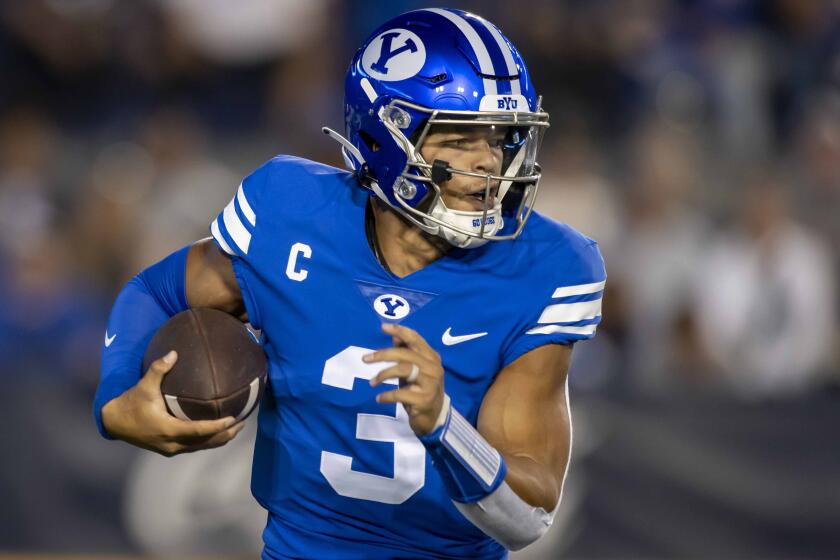 Brigham Young Cougars quarterback Jaren Hall (3) runs the football during an NCAA football game.