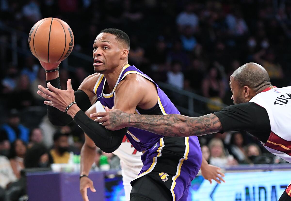 Laker Russell Westbrook is fouled by Heats P.J. Tucker while driving to the basket 