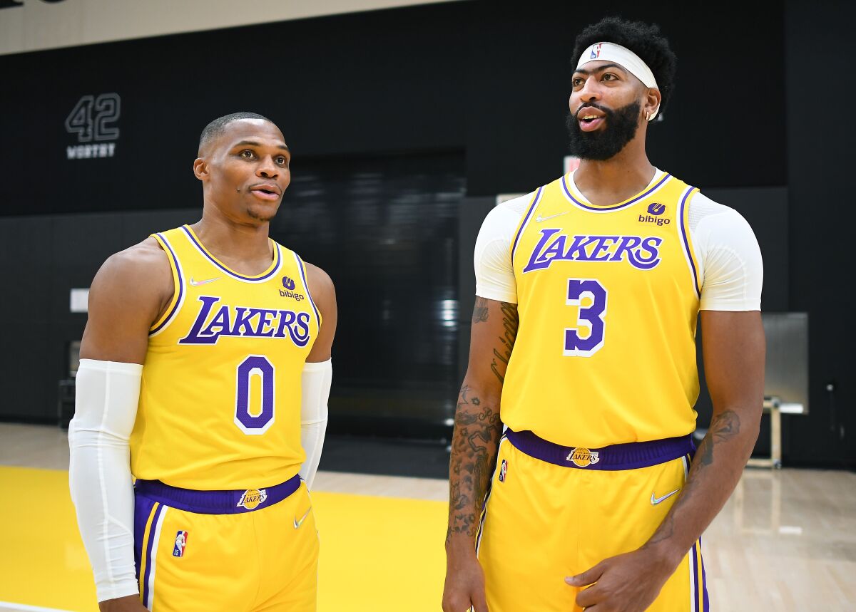 Lakers teammates Russell Westbrook, left, and Anthony Davis chat during media day in El Segundo.