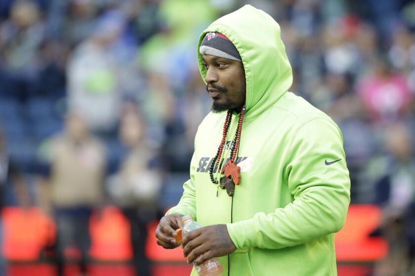 Seattle Seahawks running back Marshawn Lynch walks on the field before a game against the Detroit Lions on Monday.