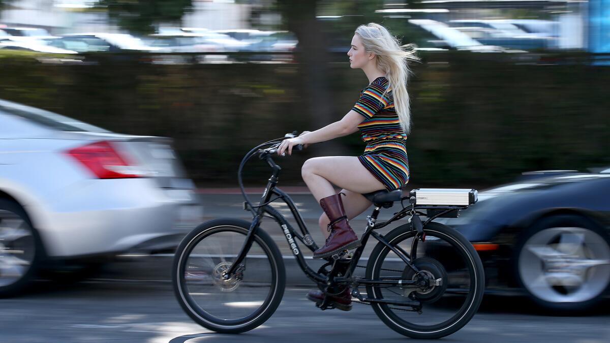 Orange County transplant Christiana Crabbe rides an e-bike through her new L.A. neighborhood.