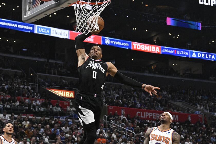 LOS ANGELES, CA -APRIL 22, 2023: LA Clippers guard Russell Westbrook (0) dunks over Phoenix Suns.