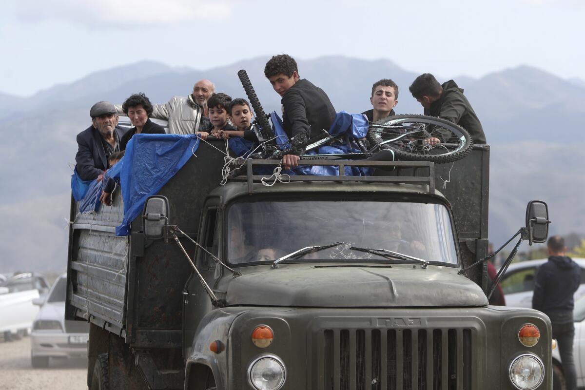 Ethnic Armenians from Nagorno-Karabakh crowded into back of truck