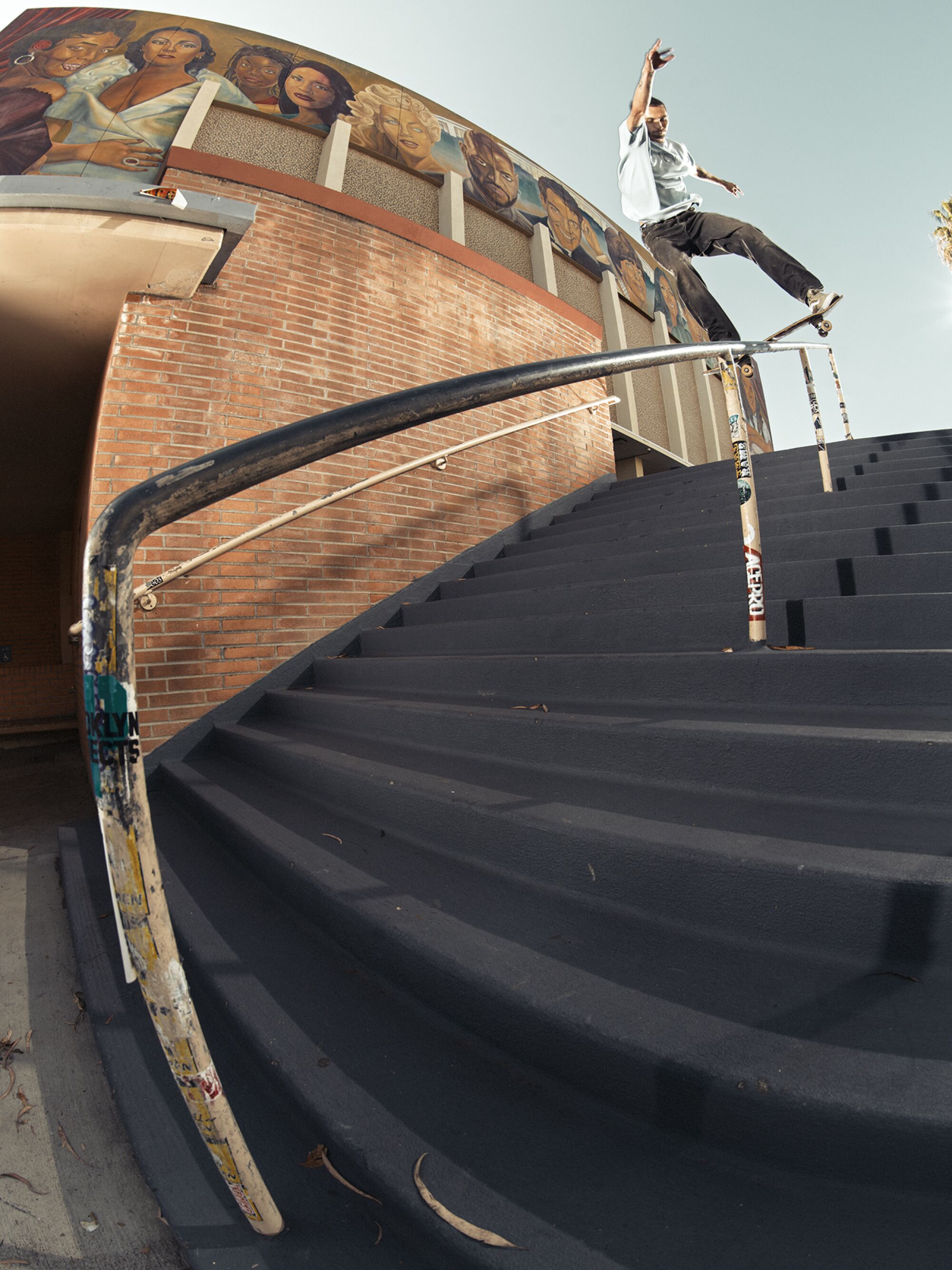 Kyle Walker slides down a rail from the top of the stairs.