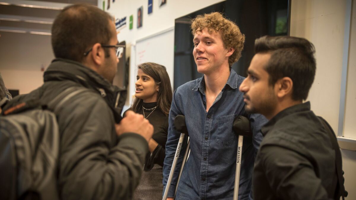 UC Berkeley student Tyler Heintz, center, speaks with students in a class that tries to find technological solutions to combat international terrorism.