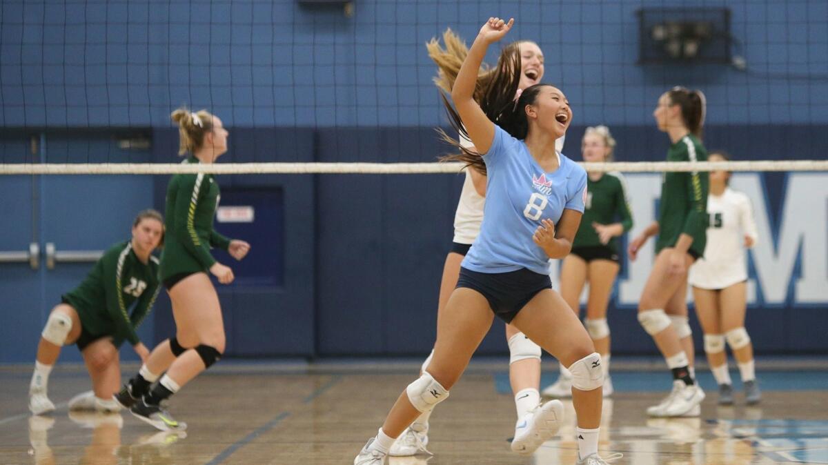 Corona del Mar High libero Michelle Won celebrates a point during a Surf League girls volleyball match against Edison on Tuesday.