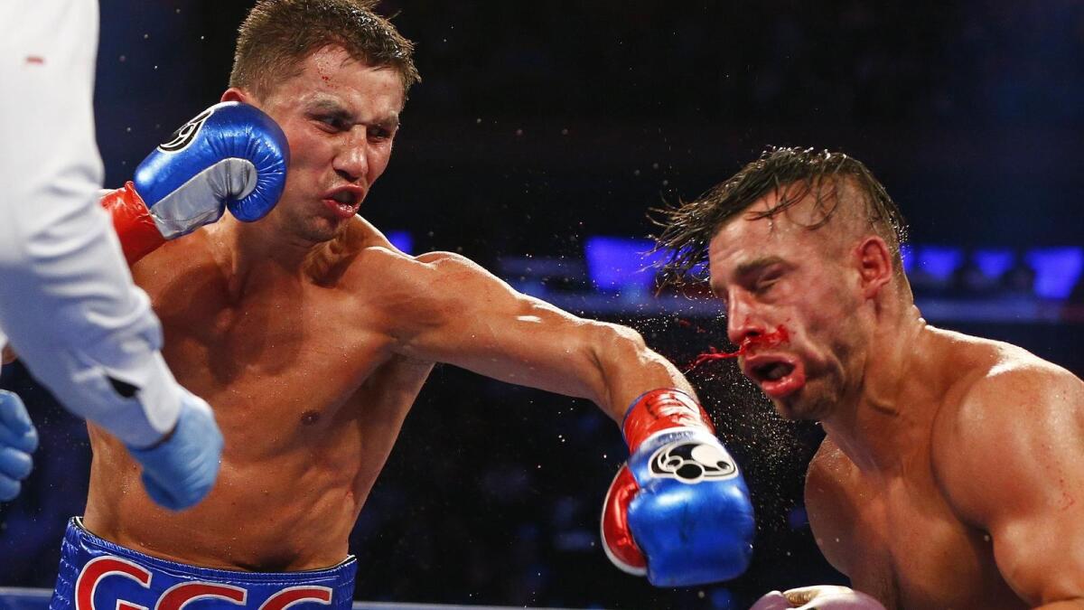 Gennady Golovkin staggers David Lemieux with a left to the head in the eighth round of their middleweight title unification fight.