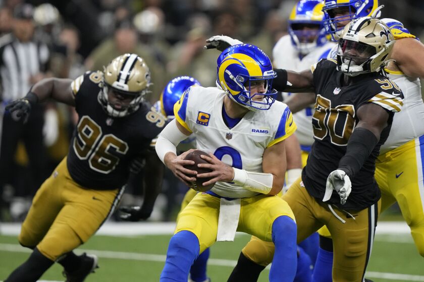 Los Angeles Rams quarterback Matthew Stafford, center, is sacked by New Orleans Saints defensive end Tanoh Kpassagnon (90) in the second half of an NFL football game in New Orleans, Sunday, Nov. 20, 2022. (AP Photo/Gerald Herbert)