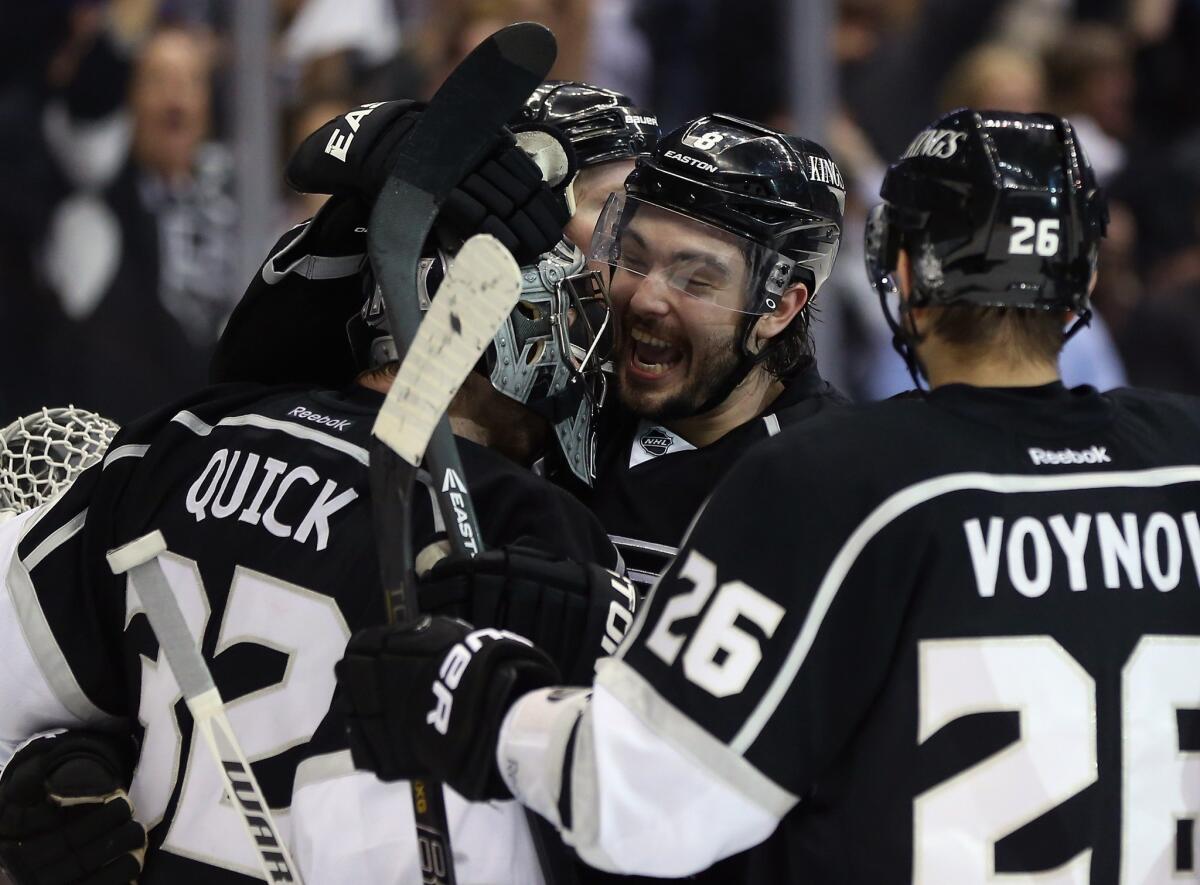 Jonathan Quick, left, Drew Doughty and Slava Voynov celebrate the Kings' 2-1 victory over the San Jose Sharks in Game 7 of their Western Conference semifinal series.