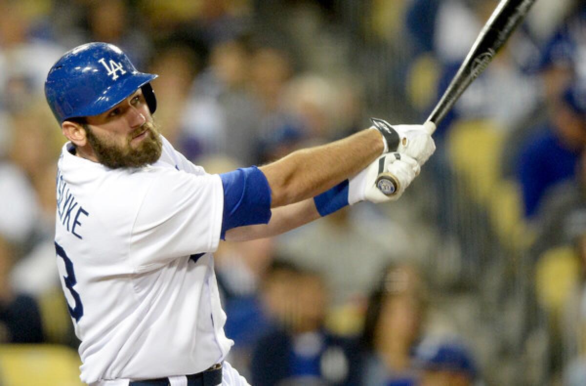 Dodgers left fielder Scott Van Slyke hits a solo home run to tie the score, 1-1, with the Arizona Diamondbacks in the seventh inning Friday night at Dodger Stadium.