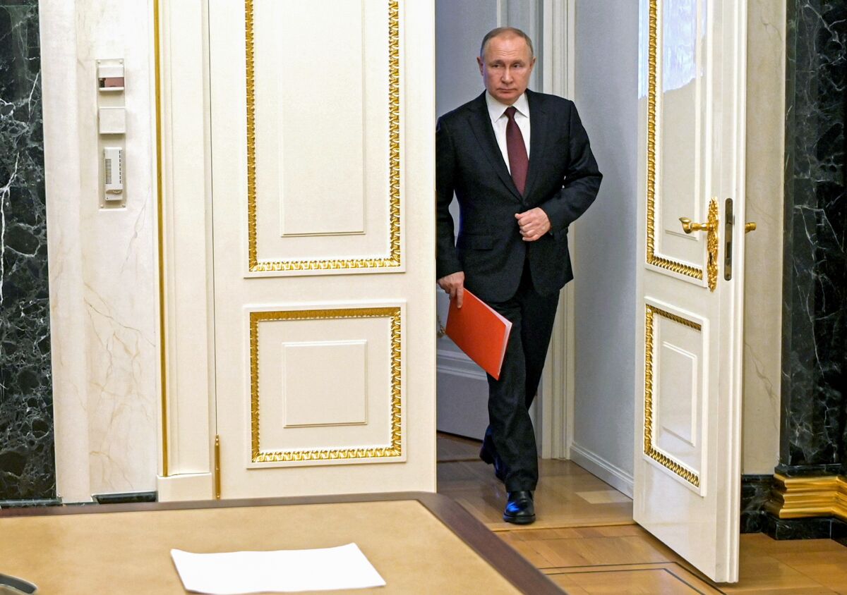 Russian President Vladimir Putin walks into a room.