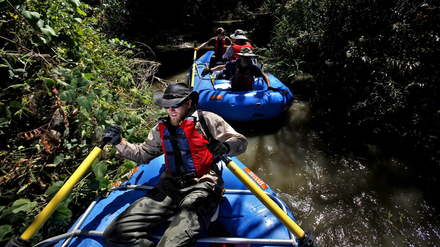 Jason Laird, 24, a ranger with the Wildlands Conservancy, paddles down a stretch of the Santa Ana River in Corona that would be managed as a recreational asset.