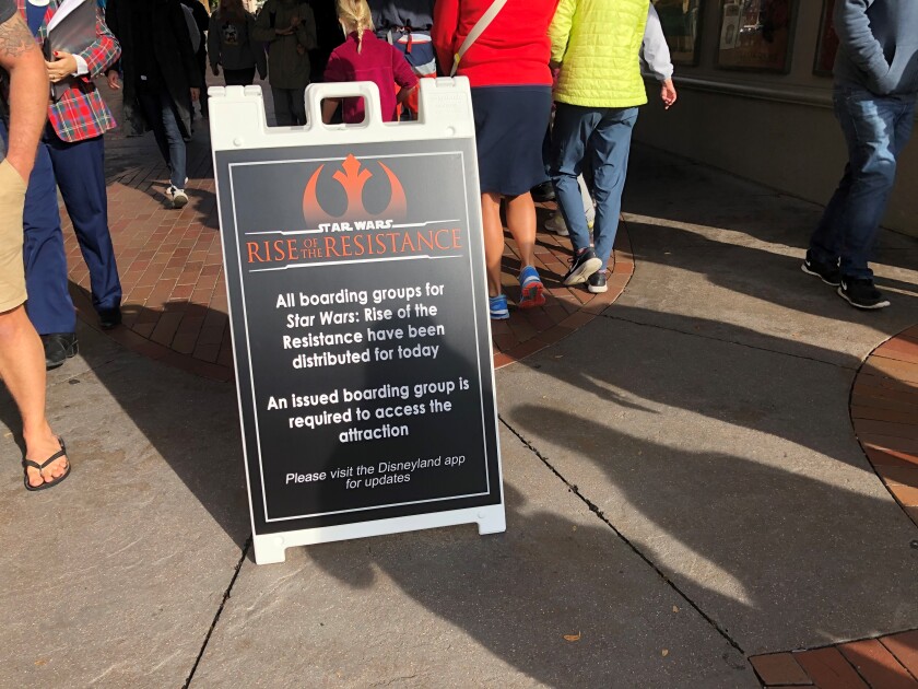 A sandwich board sign that reads, in part: "All boarding groups for Star Wars: Rise of the Resistance have been distributed for today."