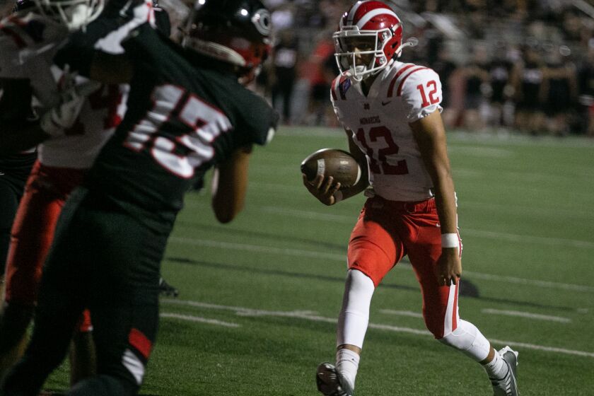 CORONA, CA - SEPTEMBER 02: Mater Dei quarterback Elijah Brown (12) runs the ball in for a touchdown in Friday night's football game between Mater Dei vs. Corona Centennial on Friday, Sept. 2, 2022 in Corona, CA. (Jason Armond / Los Angeles Times)
