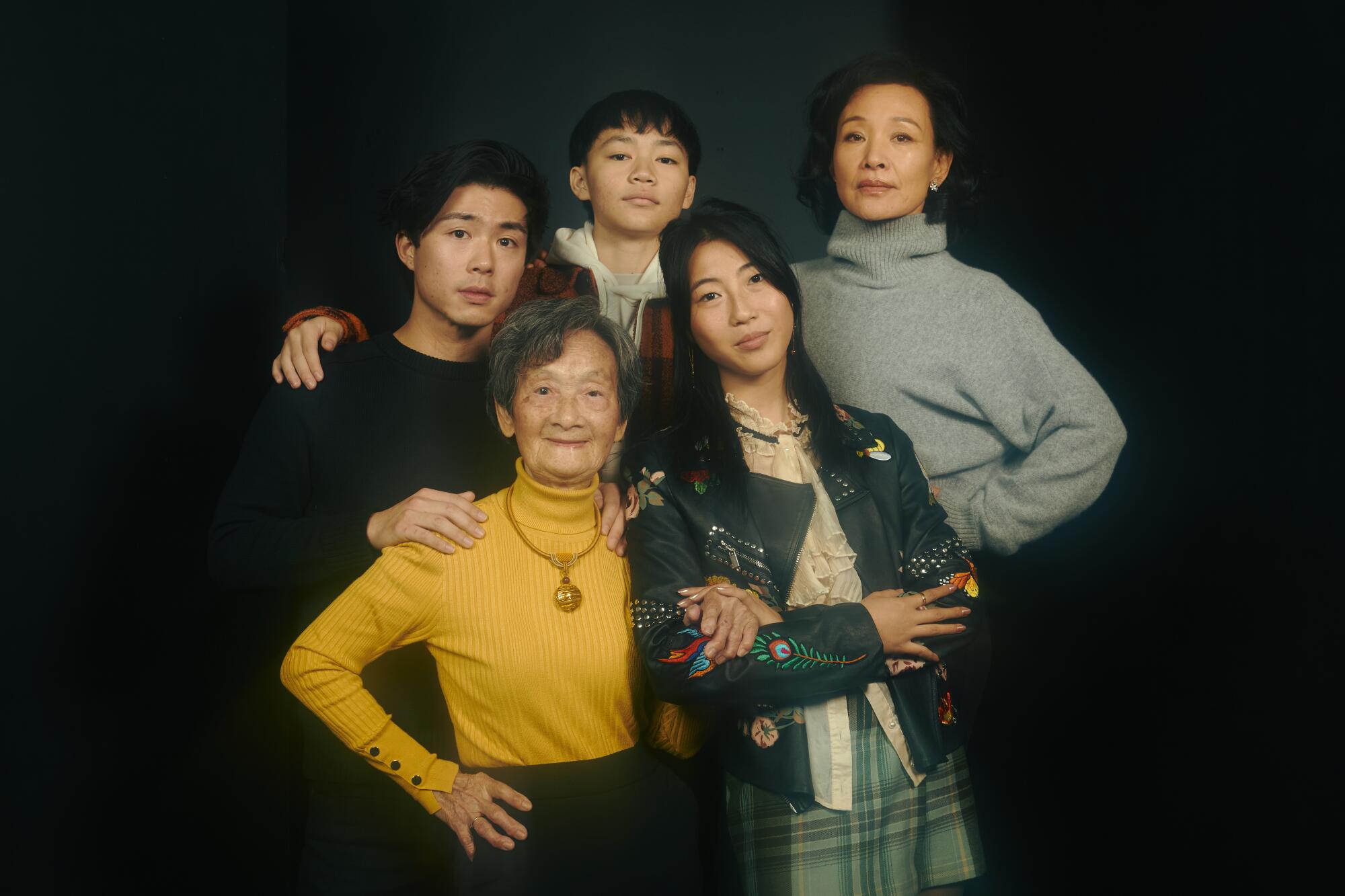 Five people pose for a portrait.
