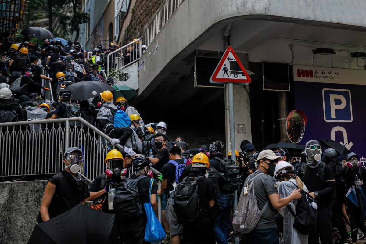 Pro-democracy demonstrators in Hong Kong retreat from police.