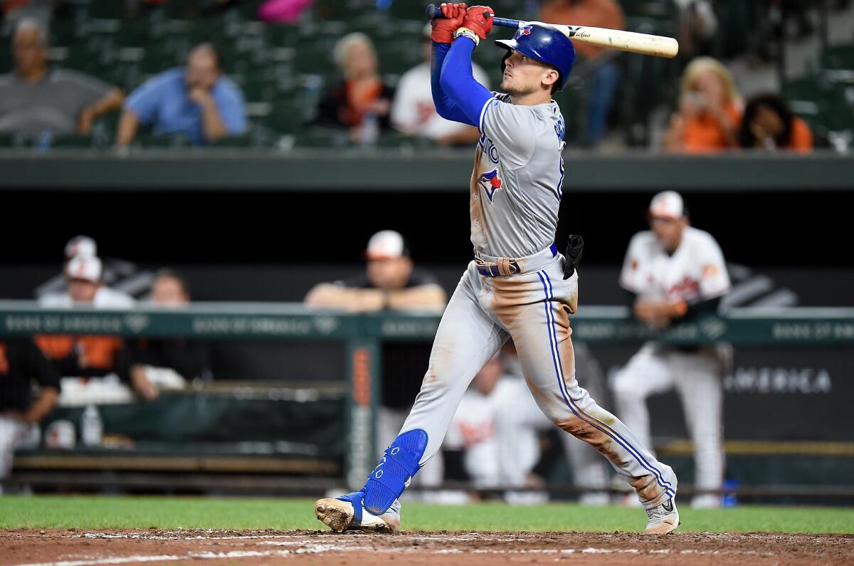 Toronto Blue Jays' Cavan Biggio hits a two-run triple in the ninth inning against the Baltimore Orioles to complete the cycle on Tuesday in Baltimore.