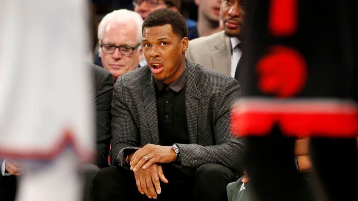 Raptors guard Kyle Lowry holds his right wrist as he watches from the bench during the first half on Feb. 27, 2017. Lowry is scheduled to have wrist surgery Tuesday.