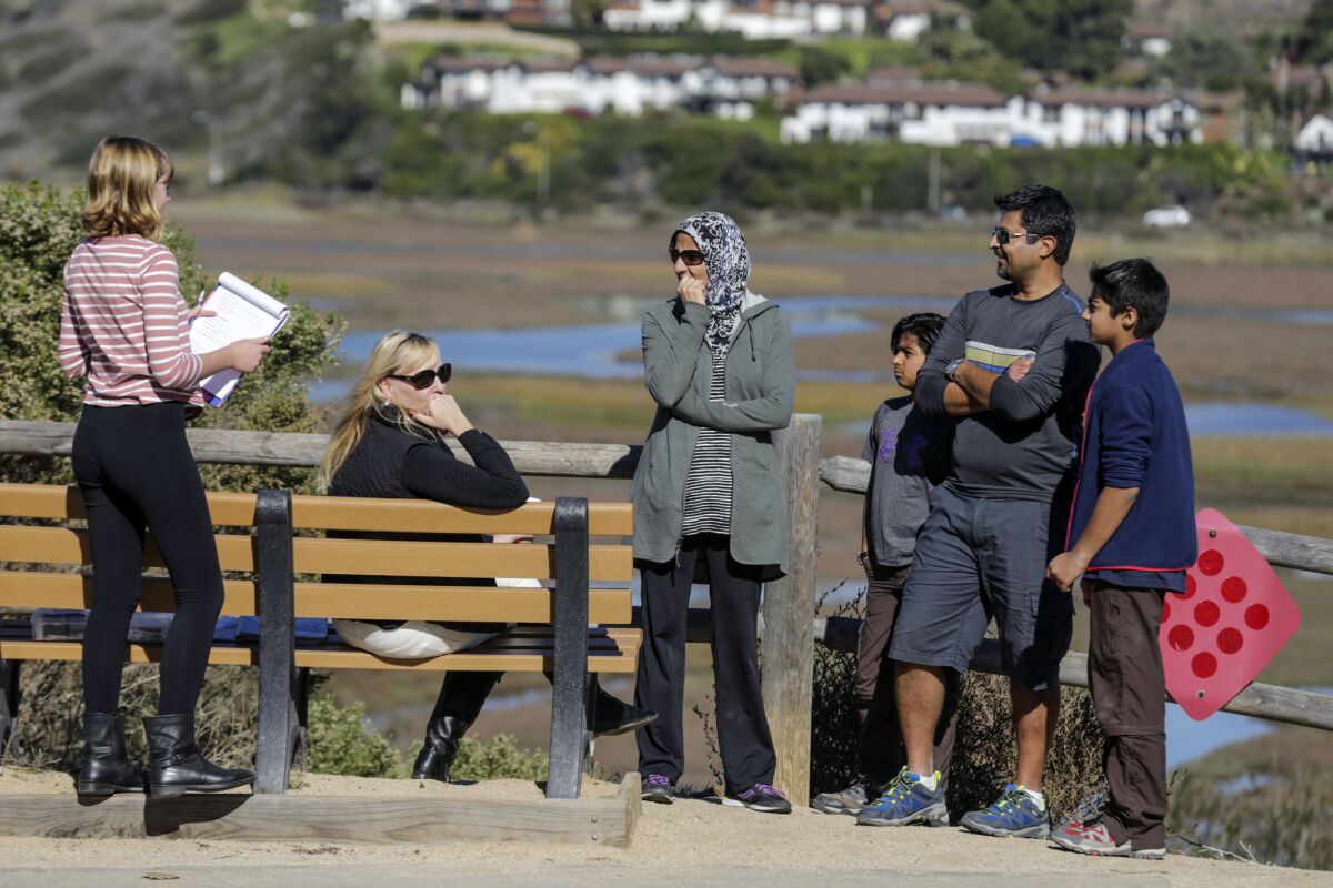 The Mahmood family walks through Annie's Canyon trail and chats with a mom from their kids' private school.