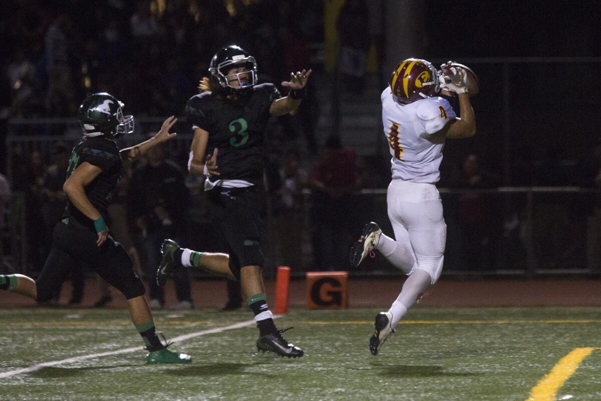 Estancia's Tony Valdez catches a pass and scores a 22-yard touchdown against Costa Mesa in the Battle for the Bell rivalry game on Friday.
