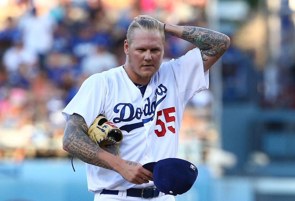 Pitcher Mat Latos was signed by the Angels Monday after an unsuccessful and brief tenure with the Dodgers this season.