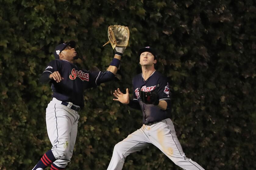Indians left fielder Rajai Davis, left, and center fielder Tyler Naquin nearly collide as Davis catches a fly ball in the bottom of the fifth inning of World Series Game 4 on Oct. 29.