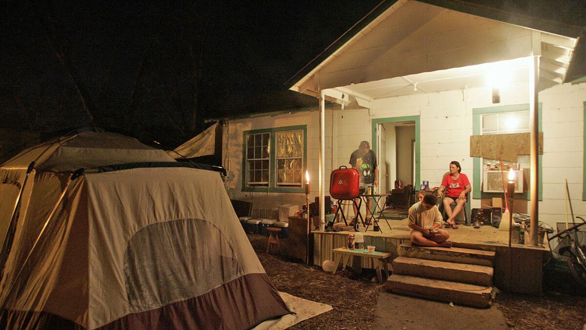 The Zirlotts have been eating their meals on their home's front porch and sleeping in a tent since Hurricane Katrina struck two weeks ago. Their home needs to dry out before it can be reoccupied.