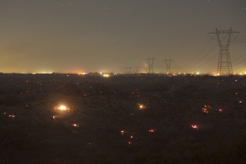 Embers burn near Victorville after the North fire jumped a freeway. A new poll shows that Californians are concerned about the effects of climate change and want state officials to prepare for potential effects such as wildfires.