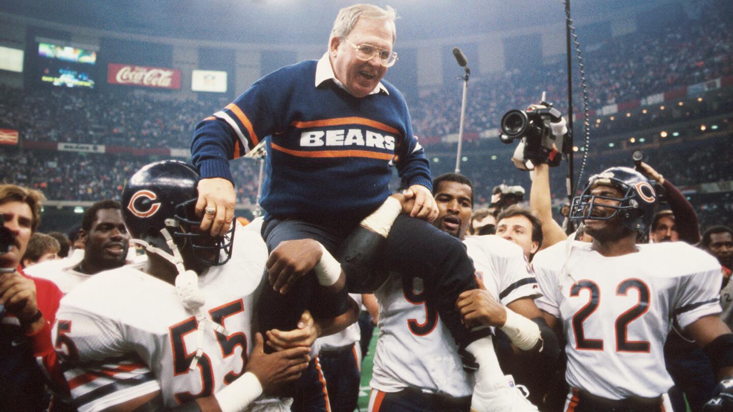 Defensive coordinator Buddy Ryan is held aloft by members of his defense including Otis Wilson #55, Richard Dent #95 and Dave Duerson #22, of the Chicago Bears, during Super Bowl XX on January 26, 1986 against the New England Patriots at the Superdome in New Orleans, Louisiana.