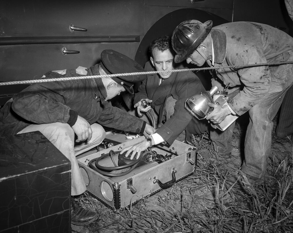 April 9, 1949: The Fiscus family physican, Robert McCullock, makes sure his oxygen equipment is ready. He hopes Kathy's silence means unconsciousness and that he'll be able to treat her.