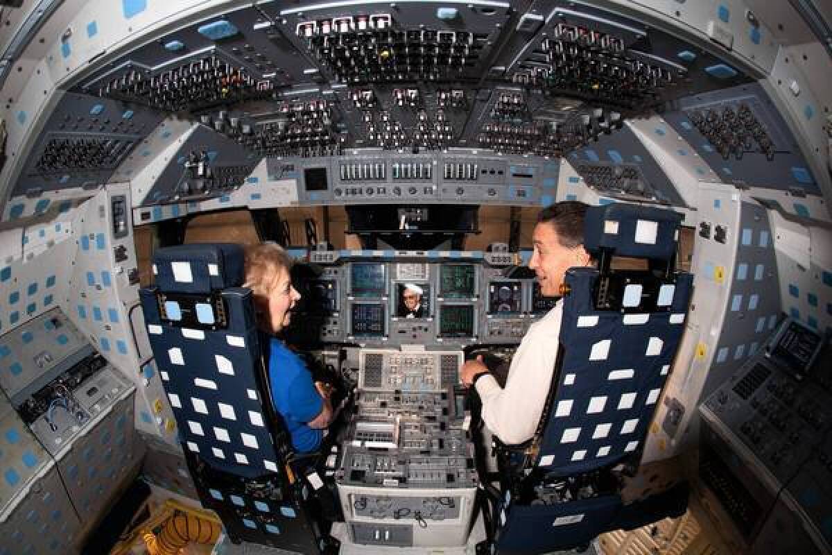 To celebrate the anniversary of the space shuttle Endeavour's journey through the streets of Los Angeles, Lynda Oschin, left, gets a tour of the flight deck with California Science Center President Jeffrey Rudolph. Panorama: Inside Endeavour's flight deck