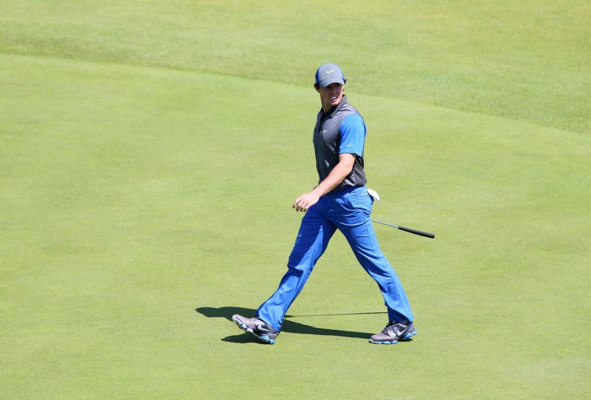 Northern Ireland's Rory McIlroy walks across the 17th green during the first round of the British Open on Thursday.