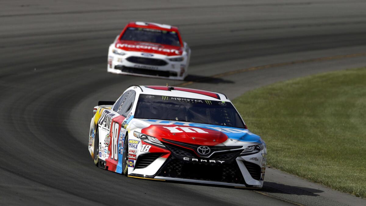 NASCAR driver Kyle Busch leads Ryan Blaney through Turn 3 during qualifying Friday at Pocono Raceway for the NASCAR Cup Series race on Sunday.