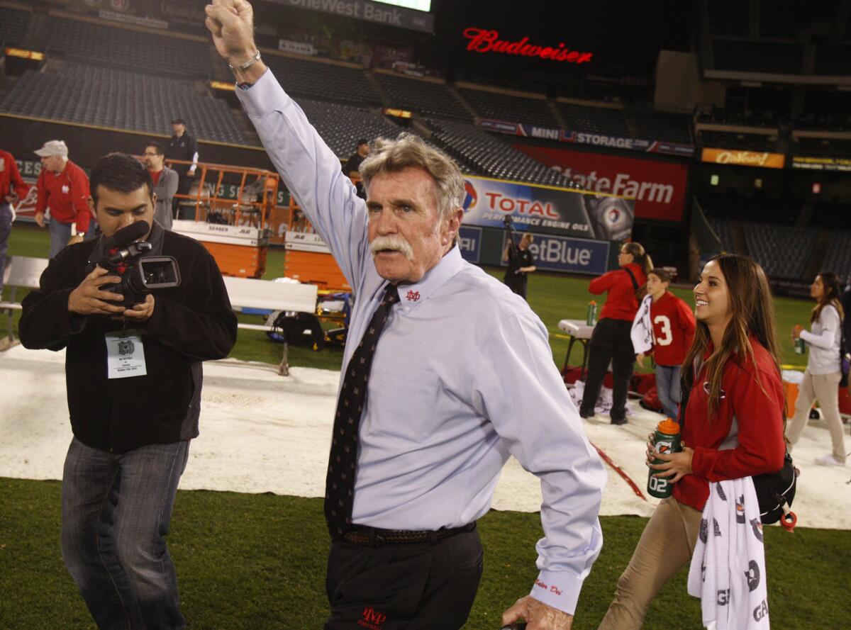 Santa Ana Mater Dei Coach Bruce Rollinson celebrates a win over Anaheim Servite on October 11, 2013.