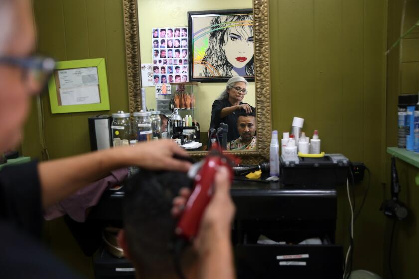 LOS ANGELES, CA-OCTOBER 18, 2019: Brooklyn Hair Styler owner Maria Garcia, left, does Jason Moya's hair on October 18, 2019, at Brooklyn Hair Styler in Los Angeles, California. Columnist Steve Lopez is at the salon learning Spanish. (Photo By Dania Maxwell / Los Angeles Times)