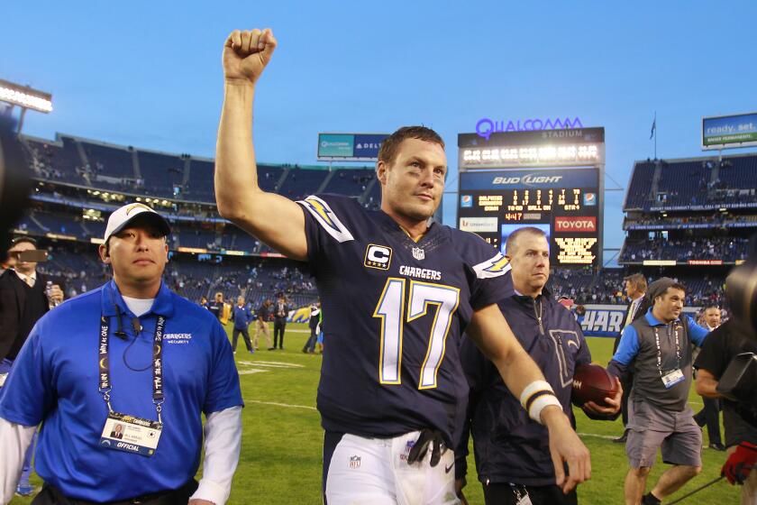 Chargers quarterback Philip Rivers salutes the fans after a 30-14 win over Miami at Qualcomm Stadium on Dec. 20, 2015.