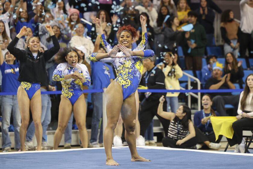 Confetti flies at the conclusion of UCLA's Nya Reed's floor routine during an NCAA gymnastics.