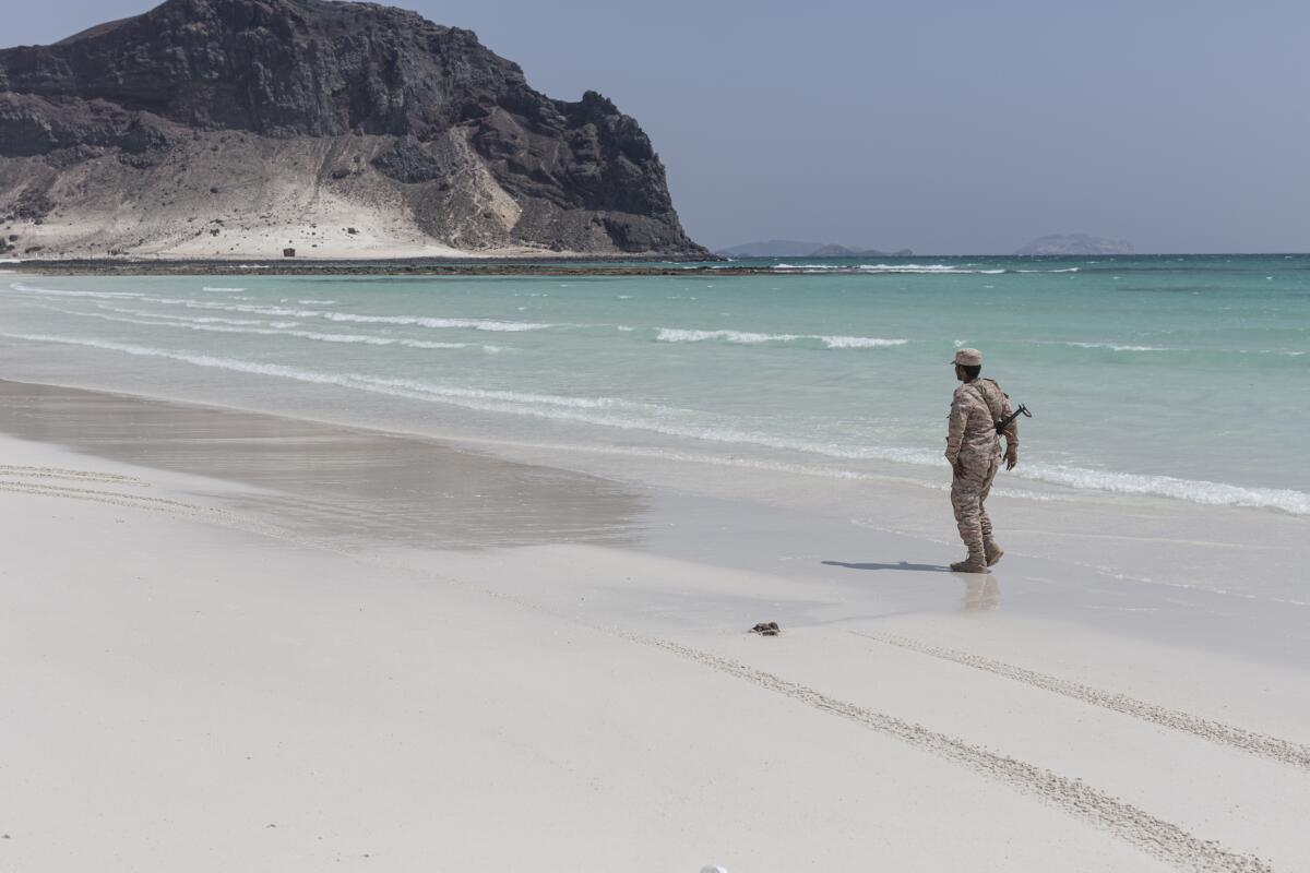 A Yemeni soldier walks along the beach at Bir Ali in Shabwa province, Yemen.