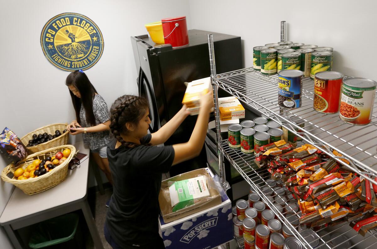UCLA student volunteers stock the shelves at UCLA's "food closet," in the Student Activities Center on campus.