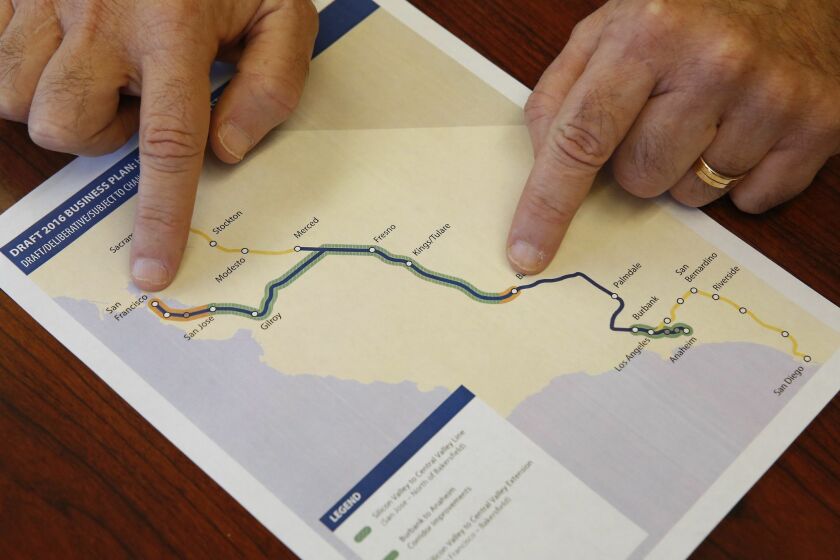 Dan Richard, chairman of the board that oversees the California High-Speed Rail Authority, gestures to a map showing the proposed initial construction of the bullet train in the revised business plan, Thursday, Feb. 18, 2016, in Sacramento, Calif. Officials of the high-speed rail system say they will push to build the first 250 miles of the system north from the Central Valley to Silicon Valley using already-approved funding for the project. (AP Photo/Rich Pedroncelli)