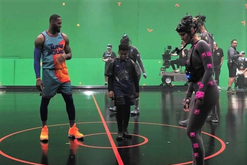 Nicole Kornet (right) lines up against LeBron James while shooting a scene for "Space Jam: A New Legacy."