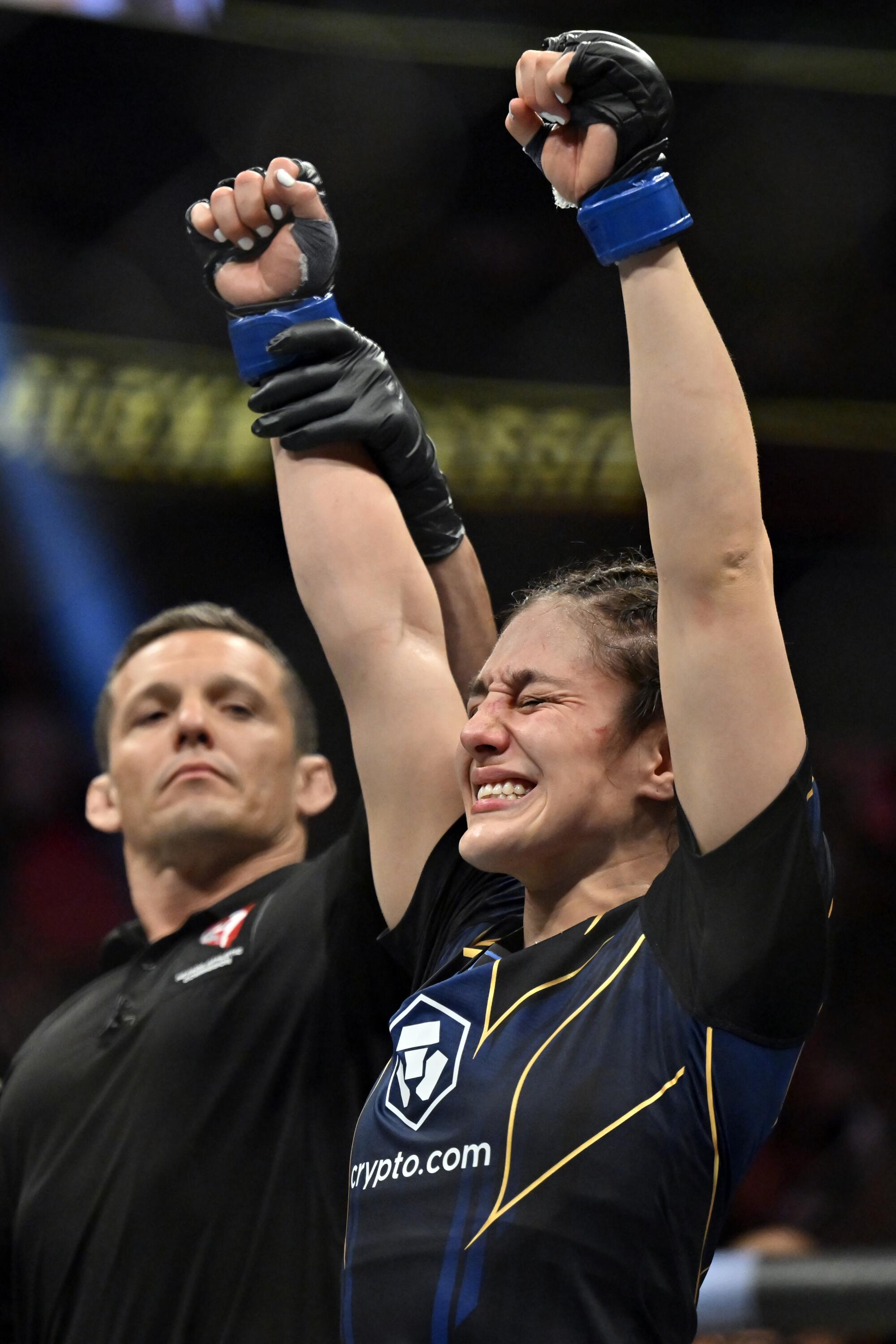 Alexa Grasso raises her arms after defeat 