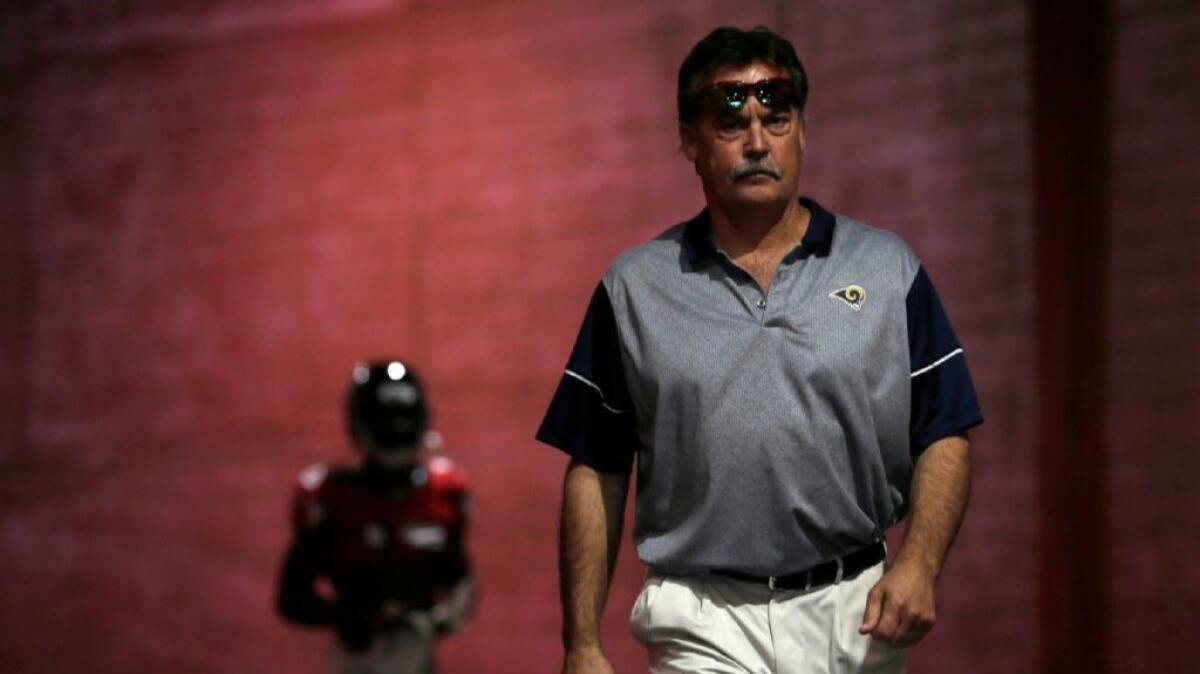 Rams Coach Jeff Fisher walks to the field before a game against the Falcons at the Coliseum. Fisher was fired Monday after leading the Rams to a 4-9 record this season.