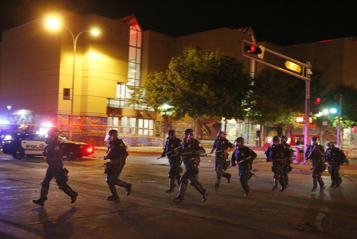 Riot police respond to anti-Trump protests following a rally and speech by Republican presidential candidate Donald Trump, in front of the Albuquerque Convention Center where the event was held, in Albuquerque, N.M., Tuesday, May 24, 2016.