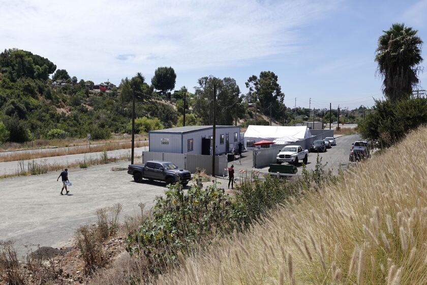 SAN DIEGO, CA - AUGUST 13: The city of San Diego installed a homeless storage facility in Chollas Triangle, shown here on Thursday, Aug. 13, 2020 in San Diego, CA. The city plans to turn the area into a park. (K.C. Alfred / The San Diego Union-Tribune)