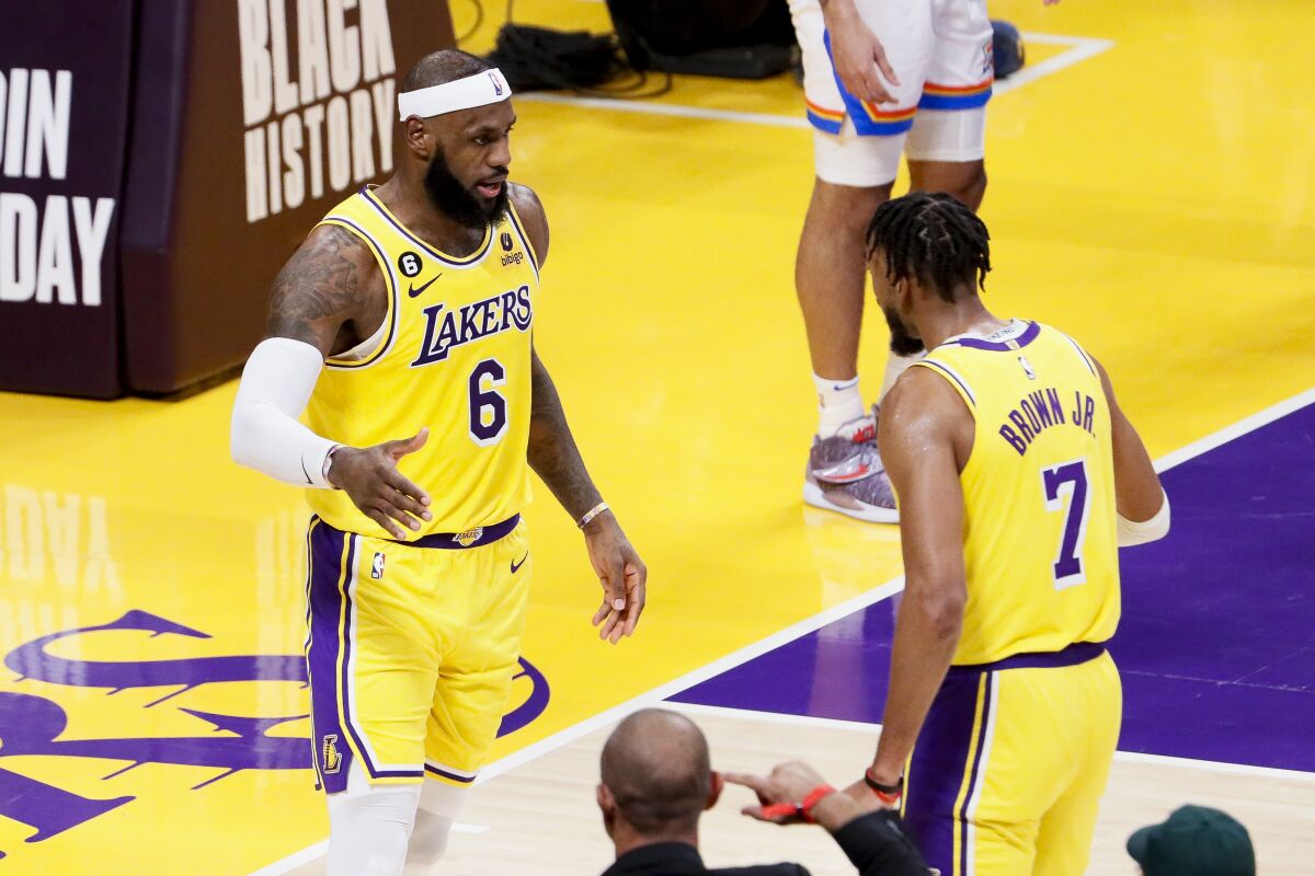 Lakers forward LeBron James (6) celebrates with forward Troy Brown Jr. after scoring and drawing a foul.