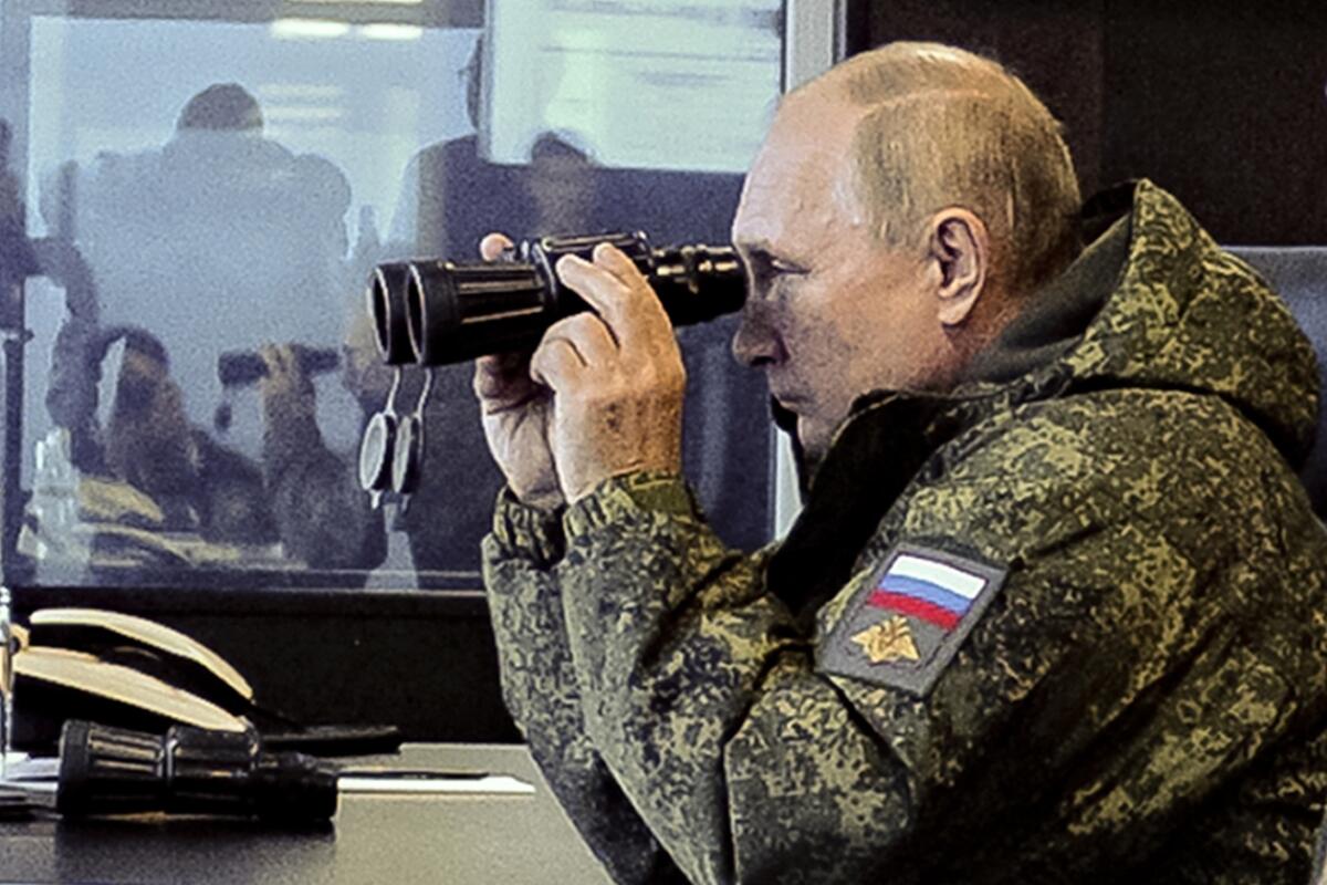 Russian President Vladimir Putin watches the Vostok 2022 (East 2022) military exercise in far eastern Russia, outside Vladivostok, on Tuesday, Sept. 6, 2022. The weeklong exercise that began Thursday is intended to showcase growing defense ties between Russia and China and also demonstrate that Moscow has enough troops and equipment to conduct the massive drills even as its troops are engaged in military action in Ukraine. (Mikhail Klimentyev, Sputnik, Kremlin Pool Photo via AP)