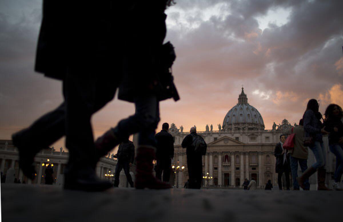 People walk outside St. Peter's Square at the Vatican.